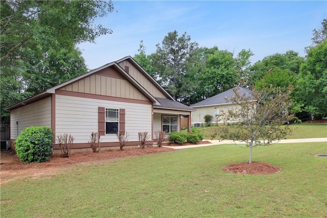 view of front of home with board and batten siding and a front lawn