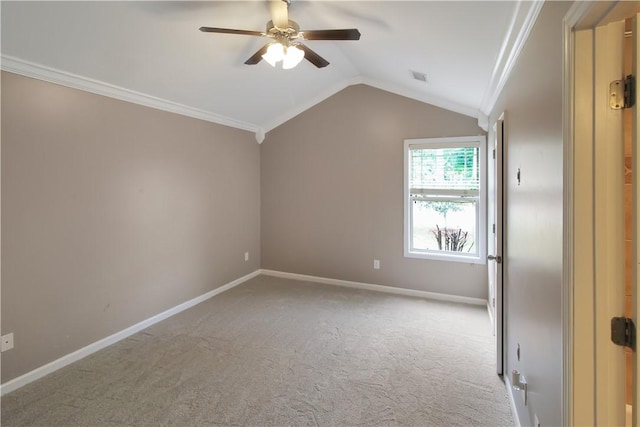 carpeted empty room with crown molding, visible vents, baseboards, ceiling fan, and vaulted ceiling