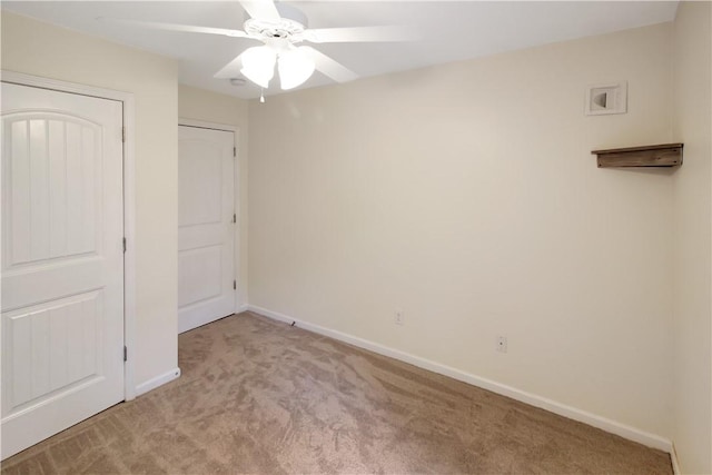 unfurnished bedroom with a ceiling fan, baseboards, and light colored carpet