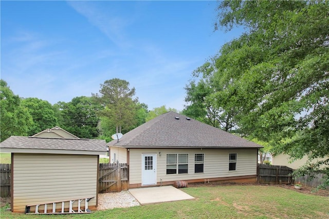 back of house featuring a yard, a patio, and a fenced backyard