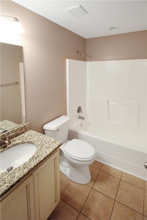 bathroom with vanity, shower / bathing tub combination, tile patterned floors, and toilet