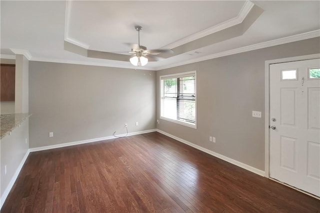 foyer entrance featuring crown molding, a ceiling fan, dark wood-style floors, and a raised ceiling