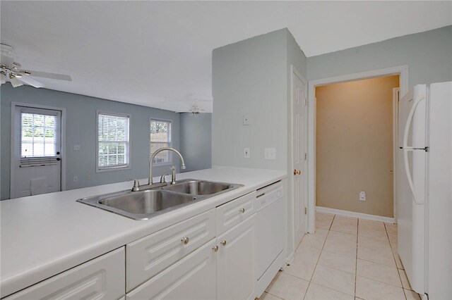 kitchen featuring white appliances, a sink, light countertops, and a ceiling fan