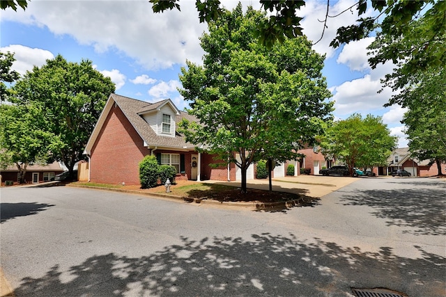view of front facade with brick siding and driveway