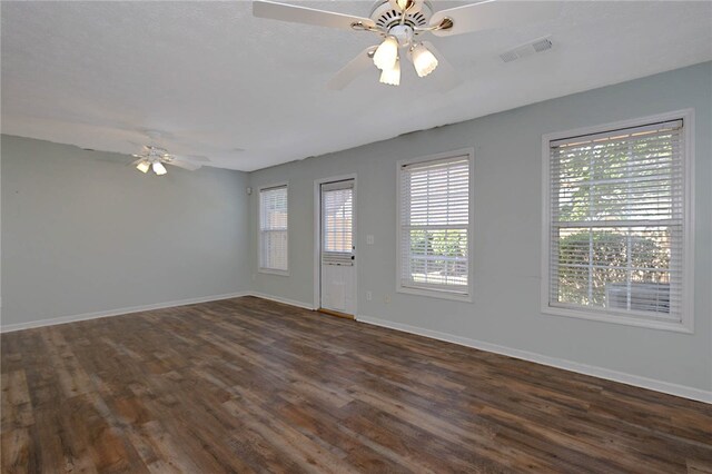 foyer featuring ceiling fan, dark wood-style floors, and baseboards