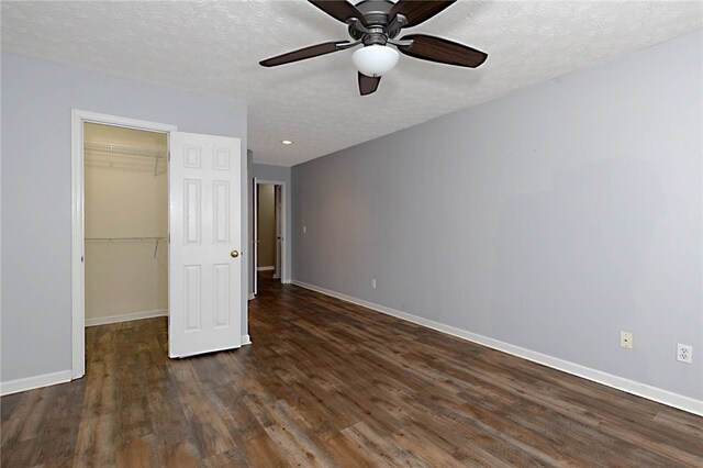 unfurnished bedroom featuring baseboards, dark wood-style floors, a closet, a textured ceiling, and recessed lighting