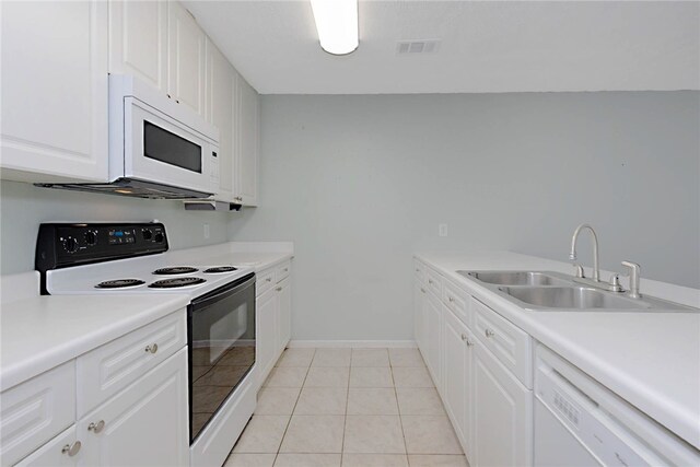 kitchen with white appliances, a sink, white cabinetry, baseboards, and light countertops