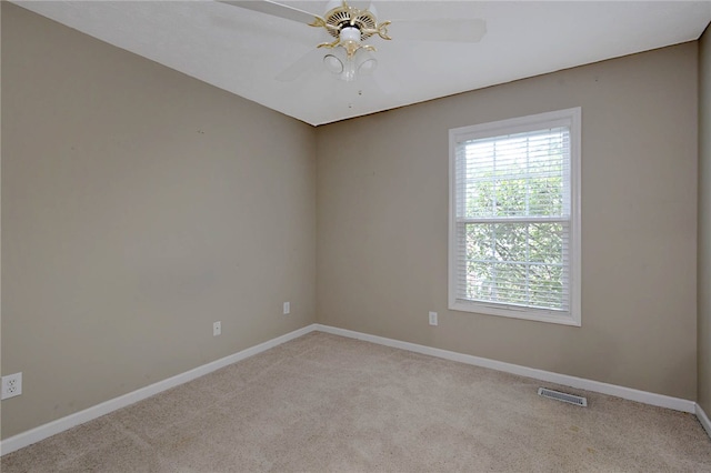 empty room with carpet floors, baseboards, and a ceiling fan