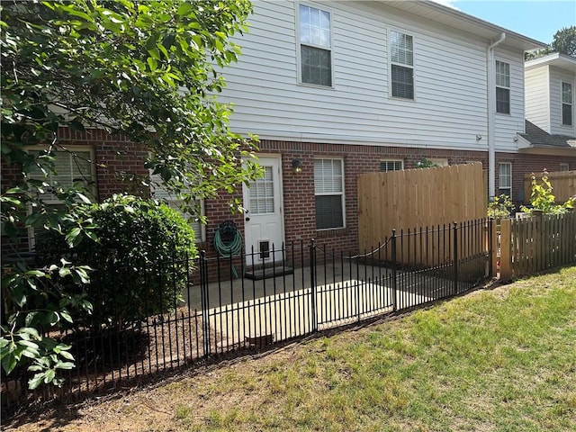 view of front of property featuring driveway, brick siding, and a garage