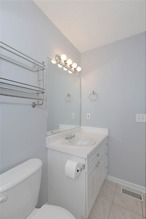 bathroom featuring toilet, tile patterned floors, and vanity
