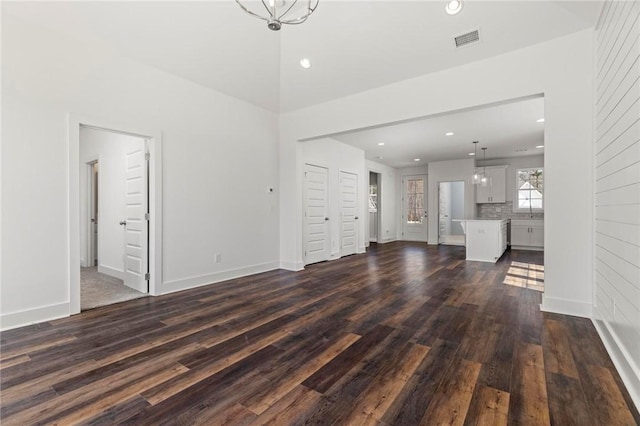 unfurnished living room featuring recessed lighting, visible vents, and dark wood finished floors