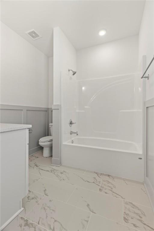 full bathroom with wainscoting, visible vents, marble finish floor, and toilet