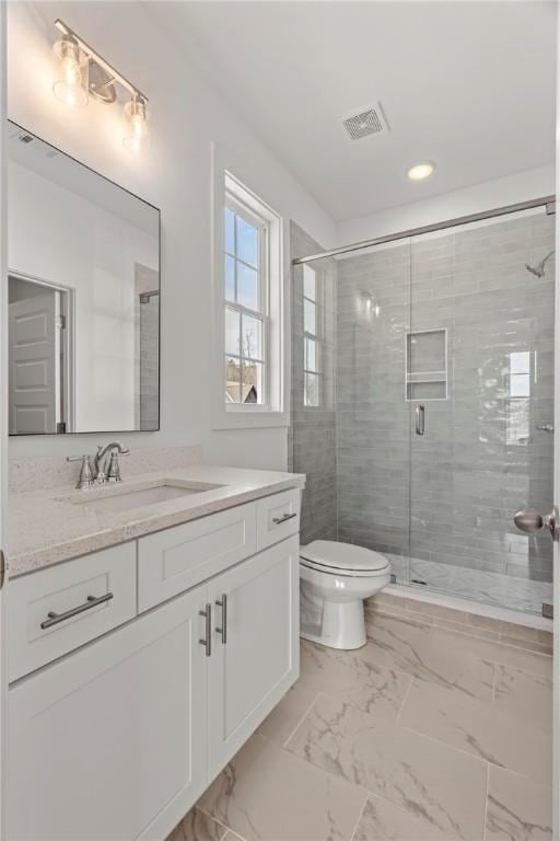 bathroom with vanity, visible vents, a stall shower, toilet, and marble finish floor