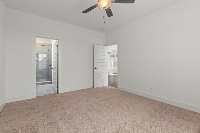 unfurnished bedroom with multiple windows, baseboards, carpet, and ensuite bathroom