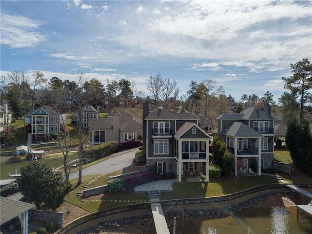 exterior space featuring a water view and a residential view