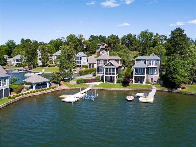 water view with a gazebo, a dock, and a residential view