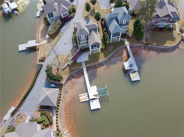 drone / aerial view featuring a water view and a residential view