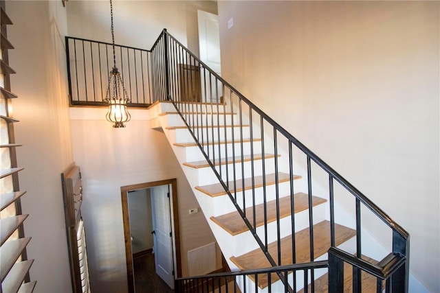 staircase with a towering ceiling