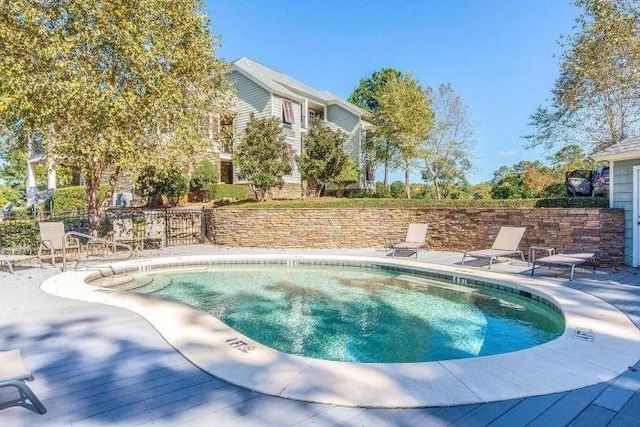 view of swimming pool featuring a pool, a patio area, and fence