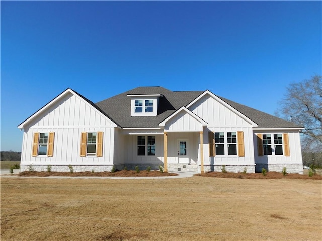 modern inspired farmhouse featuring board and batten siding and roof with shingles