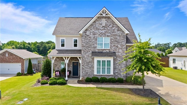 2409 Meadow Cove Rd, Auburn, AL 36832 - view of front of house featuring a porch, brick siding, driveway, and a shingled roof