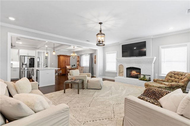 2409 Meadow Cove Rd, Auburn, AL 36832 - living room with ornamental molding, dark wood-type flooring, beam ceiling, recessed lighting, and a brick fireplace