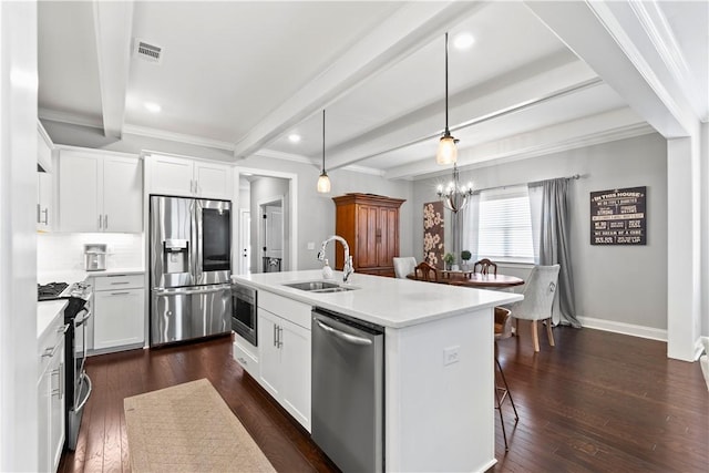 2409 Meadow Cove Rd, Auburn, AL 36832 - kitchen featuring appliances with stainless steel finishes, beam ceiling, light countertops, a kitchen island with sink, and ornamental molding