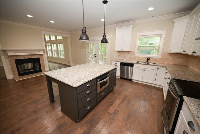 2228 Morgan Dr, Auburn, AL 36830 - unfurnished living room with a towering ceiling, dark wood finished floors, baseboards, a tile fireplace, and stairs