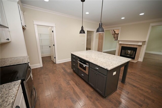 2228 Morgan Dr, Auburn, AL 36830 - living room featuring a towering ceiling, dark wood-style floors, stairs, ceiling fan, and a fireplace