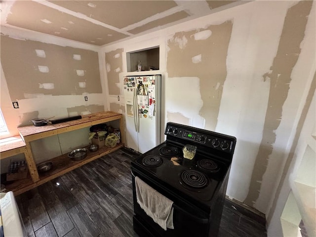 11485 US Highway 29, Tuskegee, AL 36803 - kitchen with black electric range oven, white fridge with ice dispenser, and wood finished floors
