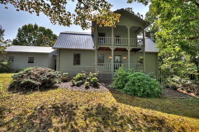 rear view of property with a balcony