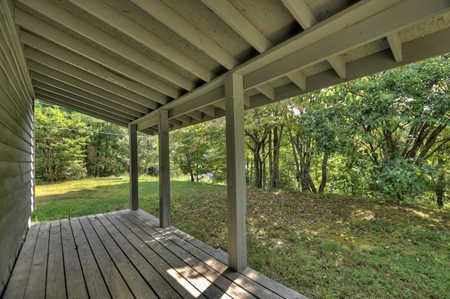 wooden terrace featuring a yard