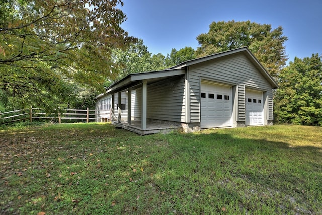 garage featuring a lawn