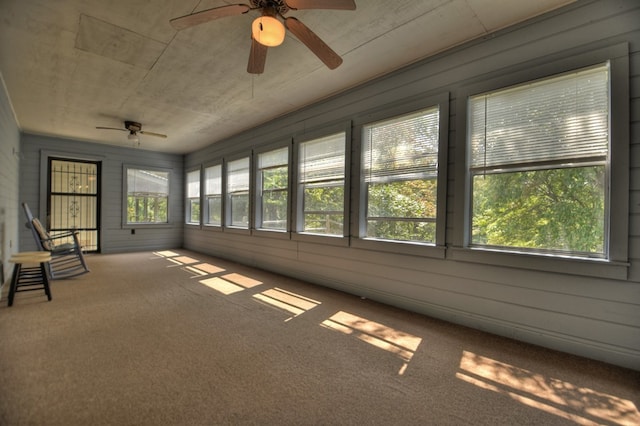 unfurnished sunroom featuring ceiling fan