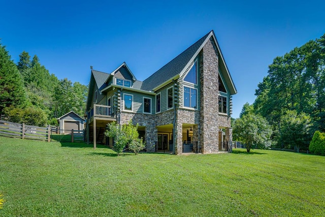 back of house with a garage, an outdoor structure, and a yard