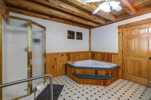 bathroom with beamed ceiling, shower with separate bathtub, wooden ceiling, and wood walls