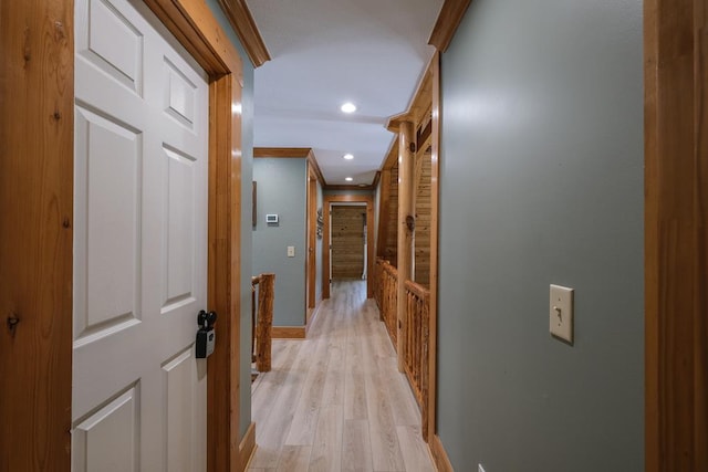 hall featuring ornamental molding and light hardwood / wood-style floors