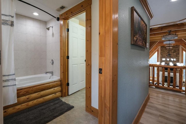 bathroom with shower / tub combo with curtain and wood-type flooring