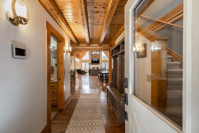 corridor with beam ceiling, wood ceiling, and dark wood-type flooring