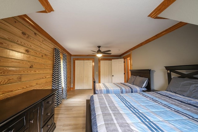 bedroom featuring crown molding, ceiling fan, and light wood-type flooring