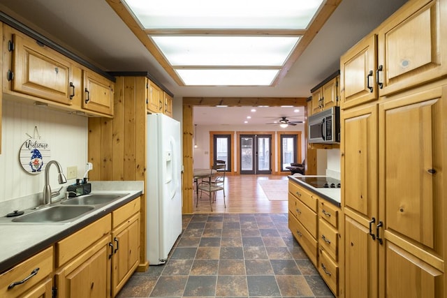 kitchen featuring black electric cooktop, sink, white refrigerator with ice dispenser, and french doors