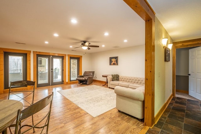 living room featuring wood-type flooring, ceiling fan, and french doors