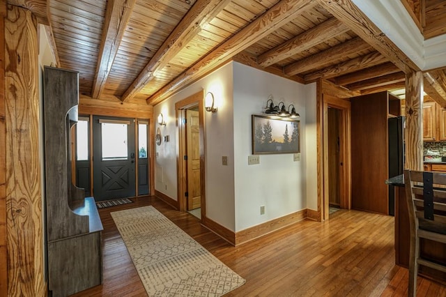 foyer featuring beam ceiling, wood-type flooring, and wooden ceiling