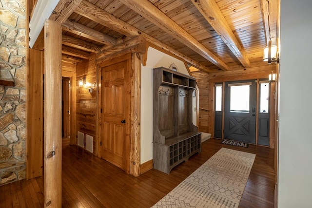 mudroom with wood walls, dark hardwood / wood-style flooring, beam ceiling, and wooden ceiling