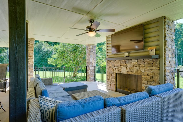 view of patio / terrace featuring an outdoor living space with a fireplace and ceiling fan