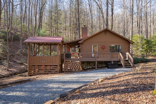 log cabin with a wooden deck