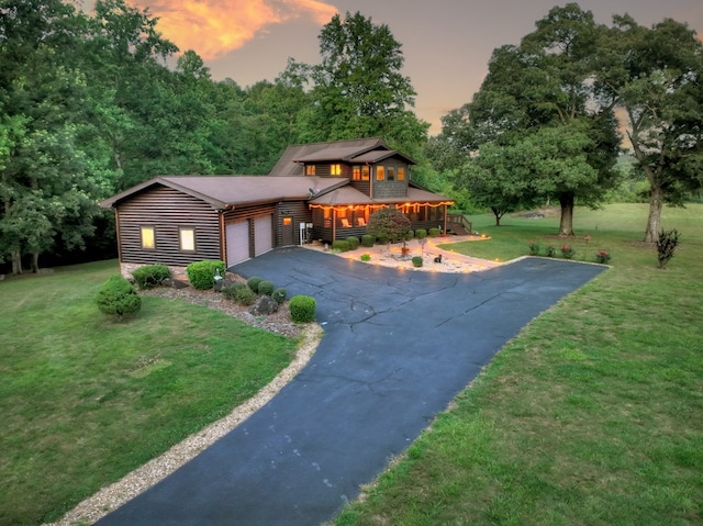 view of front of house featuring a garage and a yard