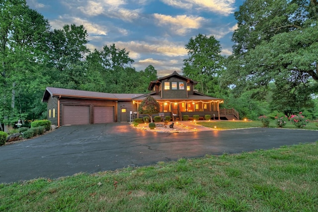 view of front facade with a garage and a porch