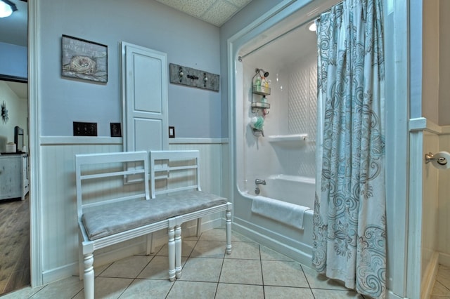 bathroom featuring a drop ceiling, shower / bath combo, and tile patterned flooring