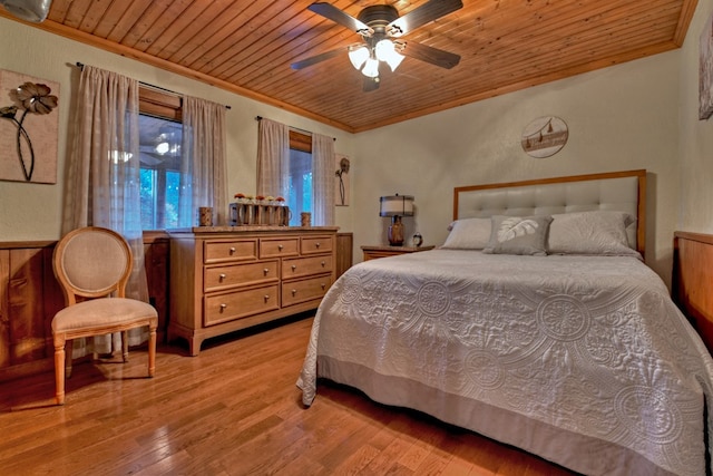 bedroom featuring ceiling fan, wooden ceiling, ornamental molding, and light hardwood / wood-style floors